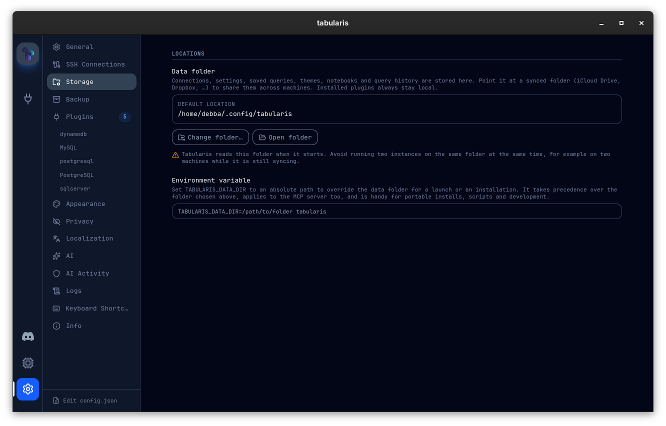 Settings → Storage: the Data folder card showing the default location, the Change folder… and Open folder buttons, the warning about running two instances on the same folder, and the TABULARIS_DATA_DIR environment variable note with a copy-ready example